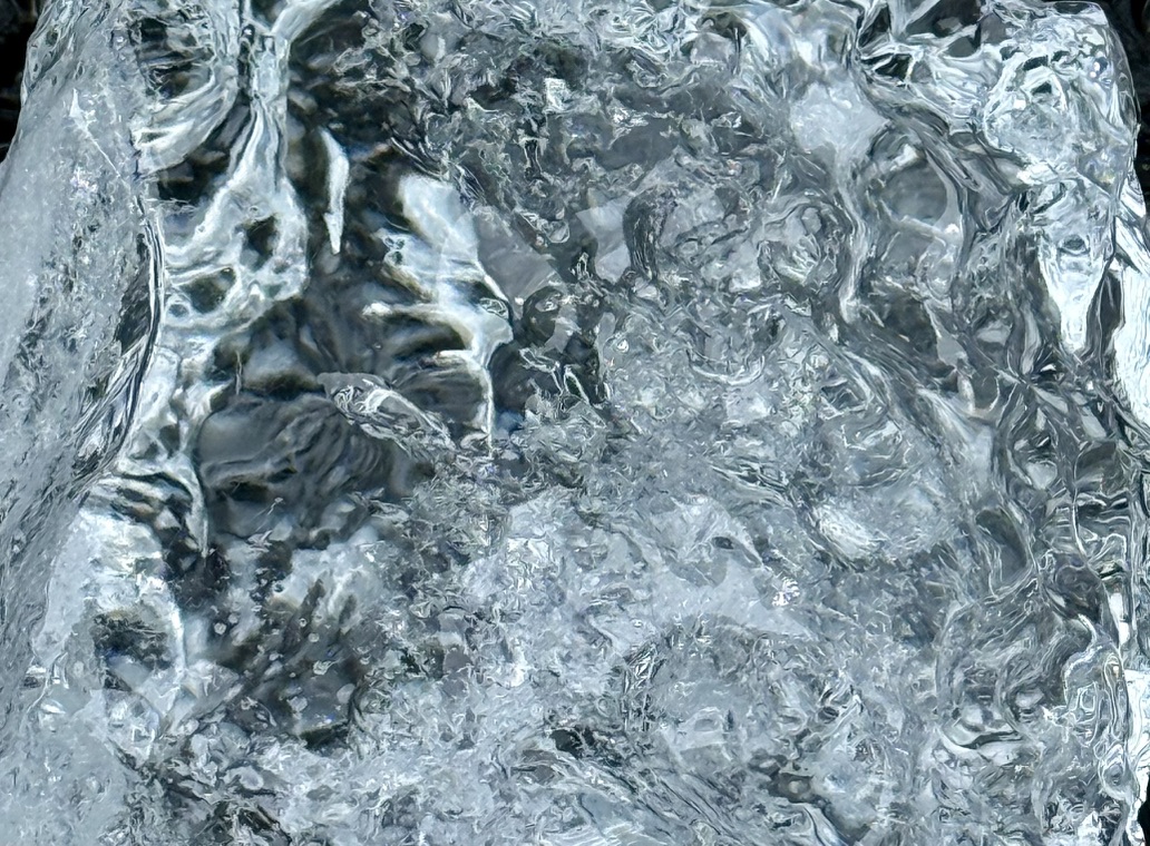 Close study of transparent Antarctic ice with rippling surfaces and refracted light