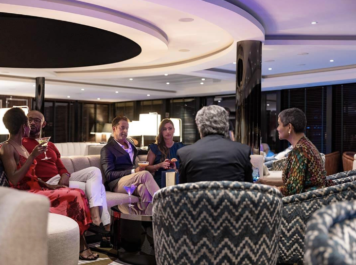 A group of guests seated together in an elegant Atlas lounge